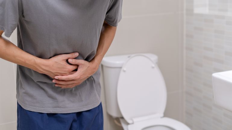 shutterstock_2168023119-copy man standing has diarrhea and severely toxic food. Man touch belly in the bathroom. Abdominal pain, Diarrhea, Colon cancer concept ; Shutterstock ID 2168023119; purchase_order: ajnet; job: ; client: ; other: