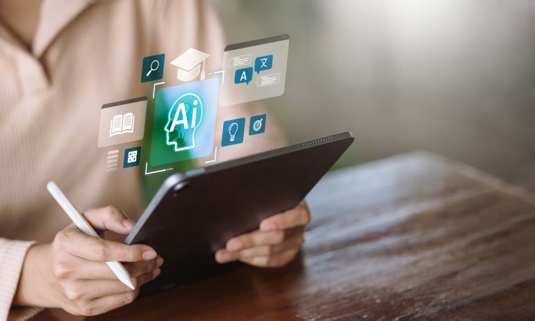 shutterstock_2678840943-1780228548 Person using tablet with stylus showing artificial intelligence icons for education, translation, book, and ideas. Concept of AI in learning, smart study, and digital education technology.
