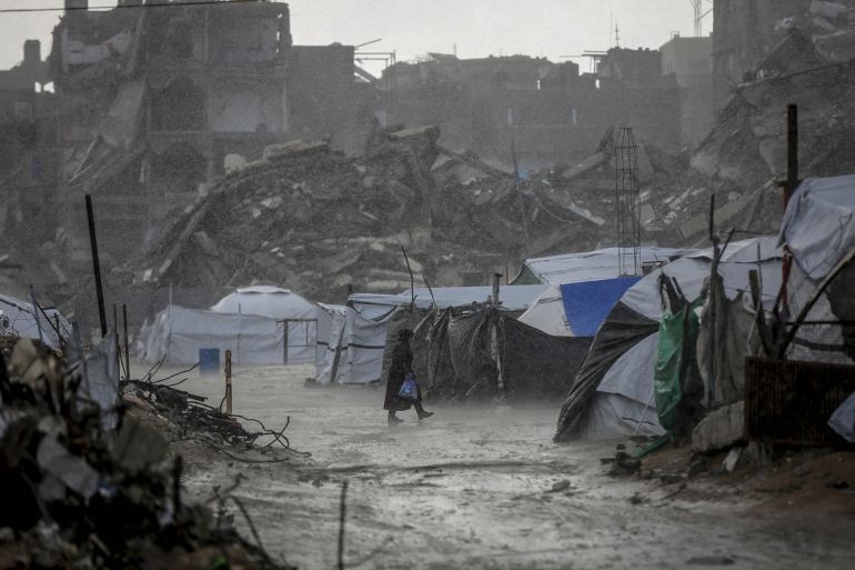 08796789-1790866480 GAZA CITY, GAZA - JANUARY 13: Palestinians struggle as heavy rain and storm damage their tents in al-Maqusi area north of Gaza City on January 13, 2026. Storms and heavy rainfall affecting the Gaza Strip have severely impacted the lives of Palestinians living in makeshift tents. (Photo by Saeed M. M. T. Jaras/Anadolu via Getty Images)