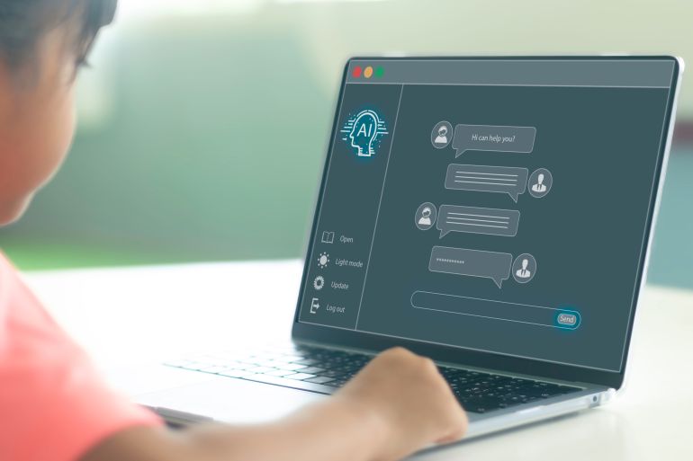 1ai-1791185095 Over the shoulder view of Asian child using laptop with AI chatbot application UI overlay, chatting with virtual assistant for interactive e-learning and AI education concept adobe stock
