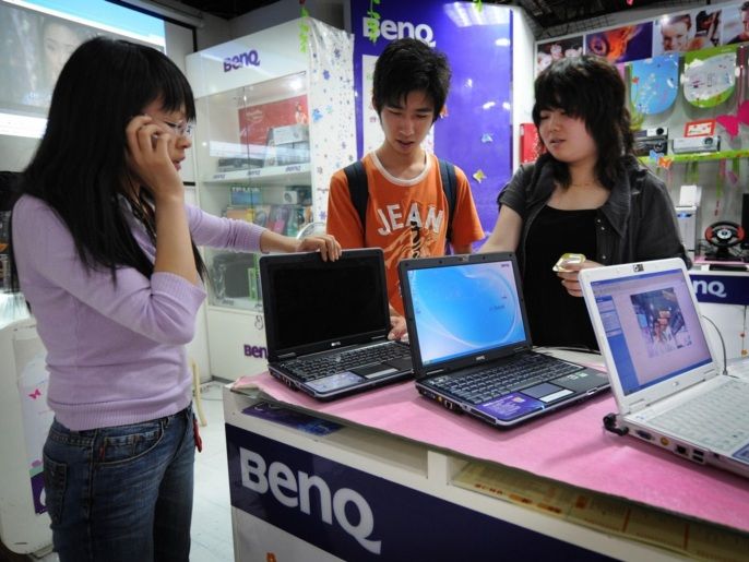 1f781ed1-c0be-4b86-9146-128a26c5f66c Chinese customers shop for Taiwanese made computers at a BenQ store in a computer mall in Shanghai on May 30, 2008. No one has been watching the dramatic thaw between China and Taiwan with more interest than the business community, which is hoping that for once politics will make their lives easier, not harder. Among the earliest results could be a decision for direct chartered flights servicing the route between Taiwan and the mainland every week, as well as an opening for Chinese tourists on the island.