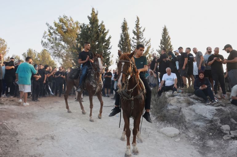 Palestinian gather on al-Rus during protests against attempts to establish Jewish settlements in the area