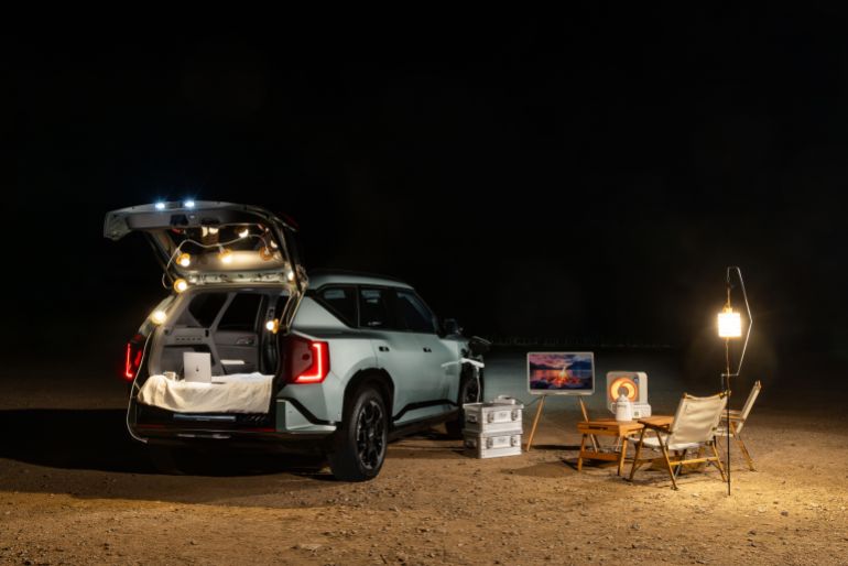 37092571-1791555484 Enjoy the perfect night camping outdoors with a car, cozy seating, and ambient lighting under the stars.