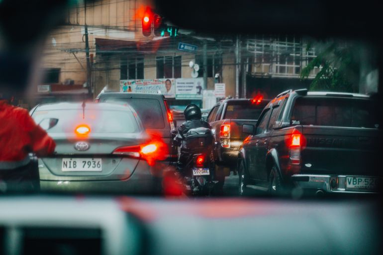 4242749-1791826429 View of a busy urban traffic jam through a car windshield on a rainy day.