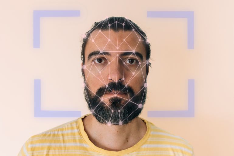 4nam-1791185292 Man's face with biometric scanning points for digital identity and security