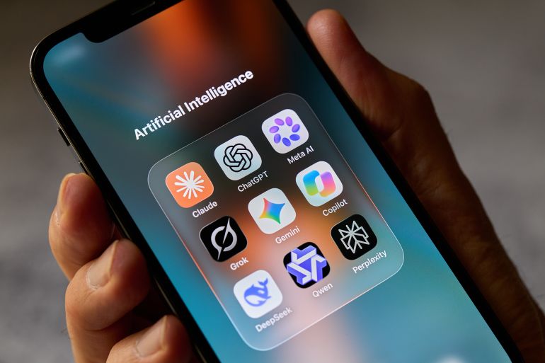 A hand holds a smartphone showing a folder labeled Artificial Intelligence that contains the app icons of Claude, ChatGPT, Meta AI, Copilot, Gemini, Grok, Perplexity, Qwen and DeepSeek, in this illustration photo taken in San Ferdinando di Puglia, Italy, on October 6, 2026. The apps are developed by Anthropic, OpenAI, Meta, Microsoft, Google, xAI, Perplexity AI, Alibaba and DeepSeek. (Photo by Matteo Della Torre/NurPhoto via Getty Images)