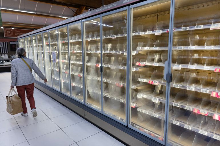65467678-4-1791870270 A woman walks past empty fresh-food refrigerators at an Intermarché supermarket in Névez, western France, on October 12, 2026, following a cyberattack affecting the French supermarket chains Intermarché and Cooperative U that caused their refrigerators to defrost. Some 150 to 200 Intermarché stores were targeted in the attack on October 12, 2026, along with nearly 100 Coopérative U outlets, the retailers said. BFM TV reported that rival giant E. Leclerc was also affected, with hackers "managing to remotely trigger the forced defrosting of refrigeration systems in numerous stores." (Photo by Fred TANNEAU / AFP via Getty Images)