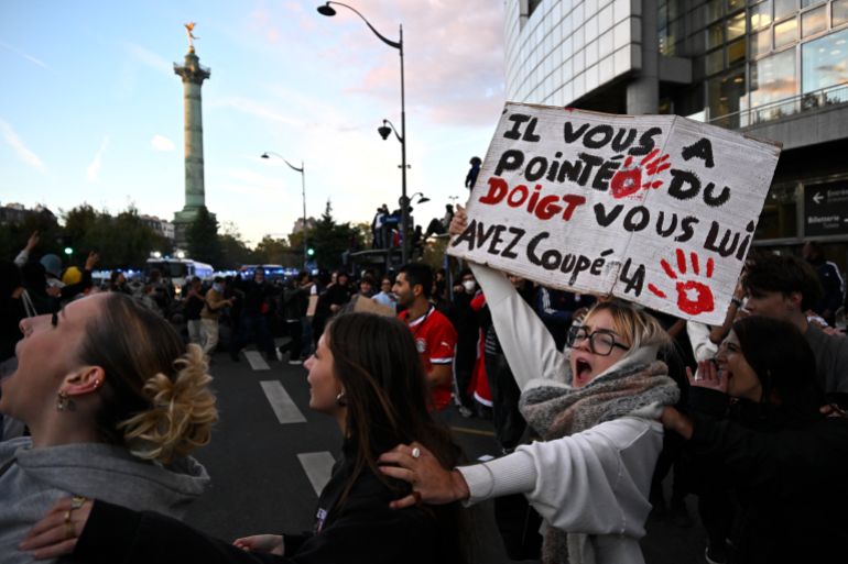 Protesters chant slogans during a demonstration of high-school students at Place de la Bastille, in Paris, on October 8, 2026, as part of a nationwide protest movement over learning conditions. Since late September, pupils have barred the entrances to hundreds of schools, complaining of teacher absences, overloaded timetables, dilapidated classrooms and buildings ill-adapted to rising temperatures, among other grievances. (Photo by JULIEN DE ROSA / AFP)