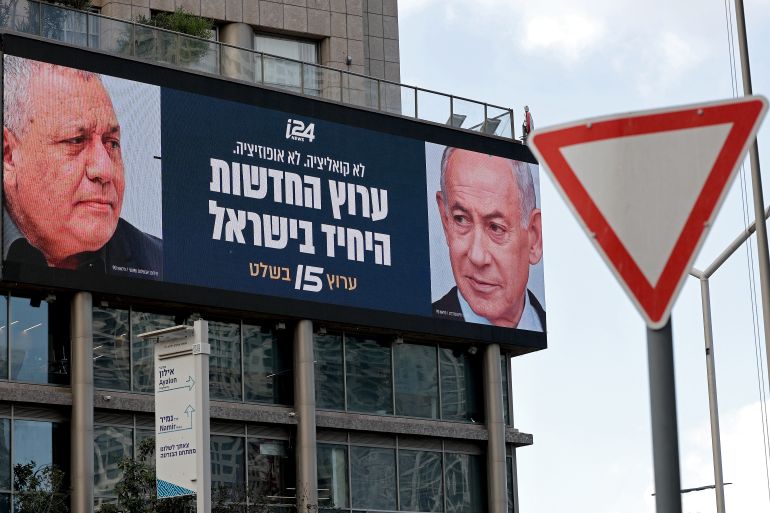 نتنياهو وغادي آيزنكوت An advertisement featuring Israel's Prime Minister Benjamin Netanyahu (R) of the Likud party and country's former chief of the general staff and leader of the Yashar centrist political party Gadi Eisenkot, is pictured next to a traffic sign board along a street in Ramat Gan on September 23, 2026. Israel heads to the polls on October 27 in its first election since the October 7, 2023 Hamas-led attack, in what is seen as a referendum on Netanyahu. (Photo by Jack GUEZ / AFP)