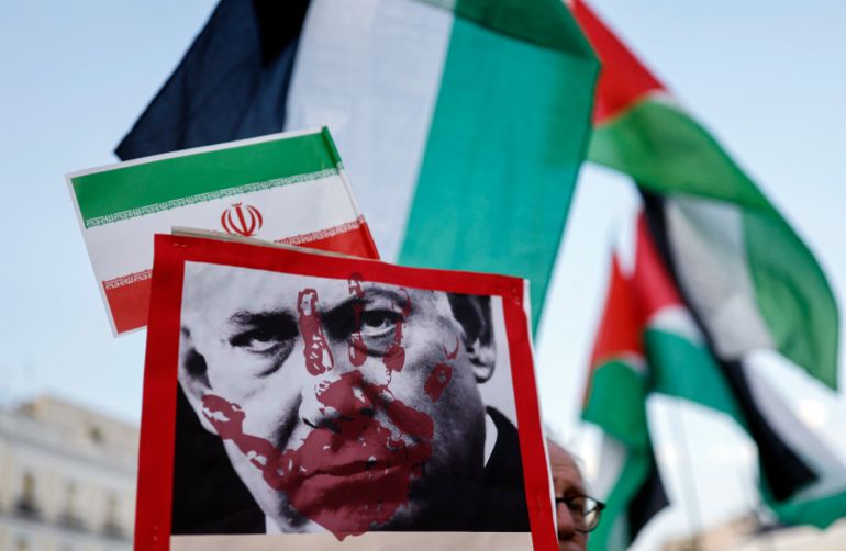 afp_68617f64168f-1751220068 Protestors hold placards showing Israeli Prime minister Benjamin Netanyahu and Iranian and Palestinian national flags during a demonstration in support of Iran and condemnation of Israel's aggression in Madrid, on June 28, 2025.