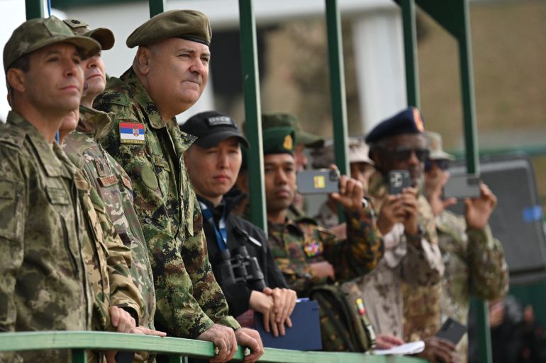 Military attaches watch the "Zapad-2025" (West-2025) joint Russian-Belarusian military drills at a training ground near the town of Borisov, east of the capital Minsk, on September 15, 2025. (Photo by Olesya KURPYAYEVA / AFP)