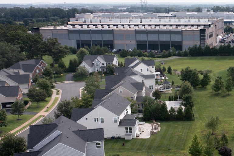 afp_6ac111c3b31c-1791037891 (FILES) This aerial view shows an Amazon Web Services (AWS) data center adjacent to single-family homes in Stone Ridge, Virginia on August 12, 2026.