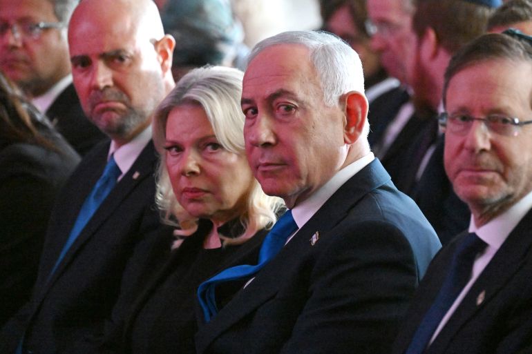 Israeli Prime Minister Benjamin Netanyahu (2R) and his wife Sara (3L) along with lawmakers attend the state memorial ceremony for the third anniversary of October 7 attack, at Mount Herzl military cemetery in Jerusalem on October 5, 2026.