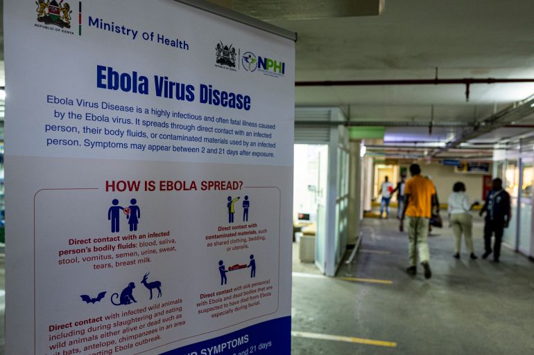 afp_6ac884b06ed4-1791526064 A passenger walks past a Port health awareness banner on Ebola at the Jomo Kenyatta International Airport in Nairobi on October 7, 2026.