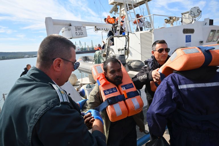 afp_6ace04e20fa2-1791886562 Crew members from a vessel struck by drones in Bulgaria's exclusive economic zone arrive at the port of Varna after being rescued on October 6, 2026.