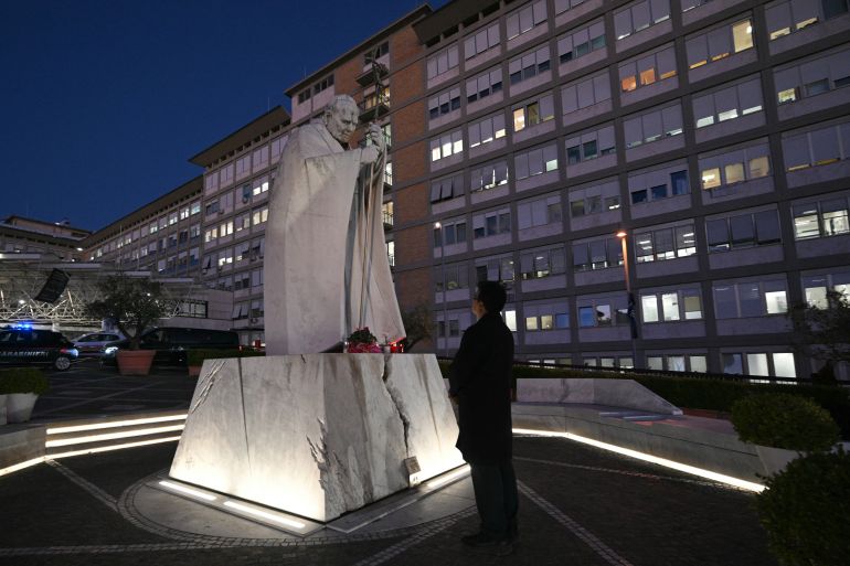 A picture shows the statue of John Paul II outside Rome's Gemelli University Hospital, where Pope Leo XIV has been admitted for an operation to remove a lump from his lung, on 13 October 2026.