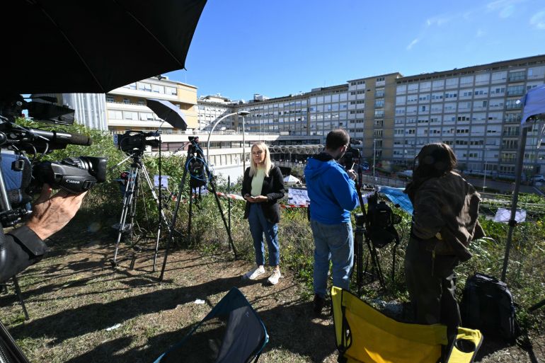 afp_6acfa27199f8-1791992433 Members of the media work outside of the Gemelli University Hospital, where Pope Leo XIV is recovering after undergoing surgery to remove a cancerous tumour from his right lung, in Rome on October 14, 2026.