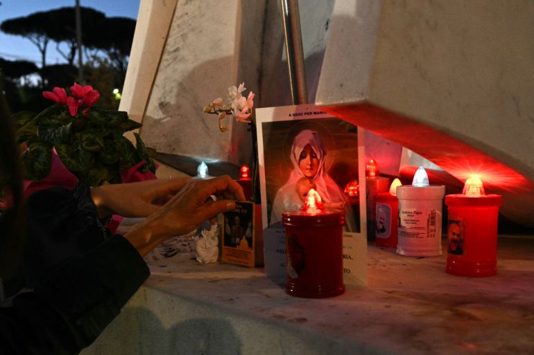 afp_6acfa4bedd73-1791993022 Candles, flowers and prayers are led at the statue of John Paul II outside Rome's Gemelli University Hospital, where Pope Leo XIV has been admitted for an operation to remove a lump from his lung, on 13 October 2026.