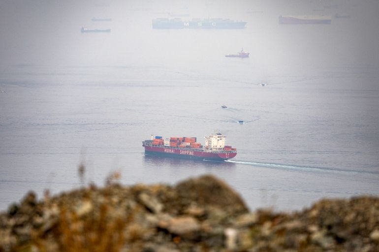 The Chinese-flagged container shipping vessel Hui Fa transits the Gulf of Oman off the coast of Khor Fakkan in the emirate of Sharjah in the east of the UAE on October 13, 2026.