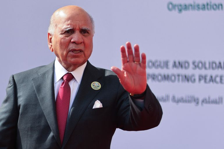 afp_6ad3984de1d4-1792251981 Iraq's Foreign Minister Fuad Hussein reacts as he takes part in the family photo at the 52nd session of the Organisation of Islamic Cooperation (OIC) Council of Foreign Ministers in Baghdad on October 17, 2026.