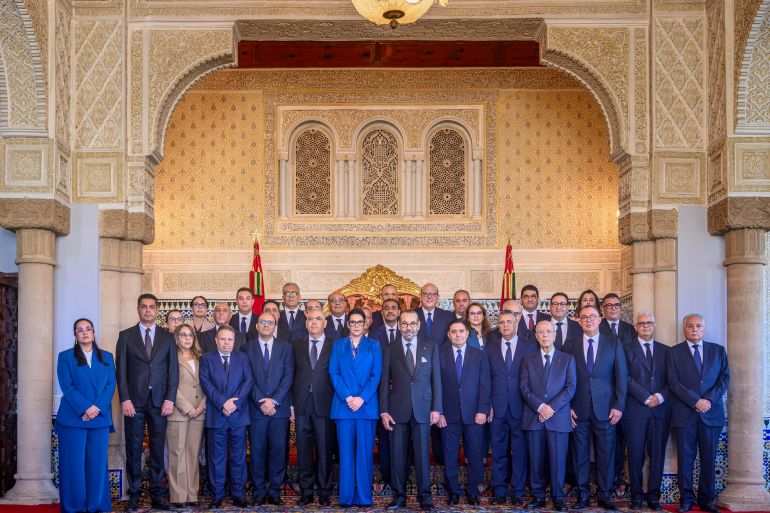 afp_6ad48f3706c6-1792315191 This handout picture taken and provided by the Moroccan Maghreb Arabe Presse (MAP) on October 16, 2026, shows Morocco's King Mohammed VI (front row C-R) posing for a picture with Morocco's Prime Minister Fatima Ezzahra El Mansouri (front row C-L) and members of the newly appointed government at the Royal Palace in Rabat.