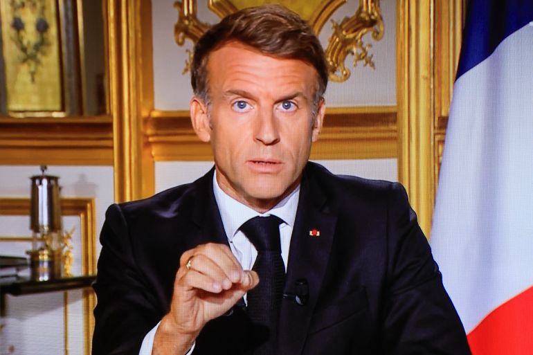 afp_6ad5192c14cb-1792350508 This photograph shows a television monitor broadcasting France's President Emmanuel Macron giving a speech from the Elysee Presidential Palace the day after riots and looting on the sidelines of nationwide protests against the "high cost of living", in Paris on October 18, 2026.