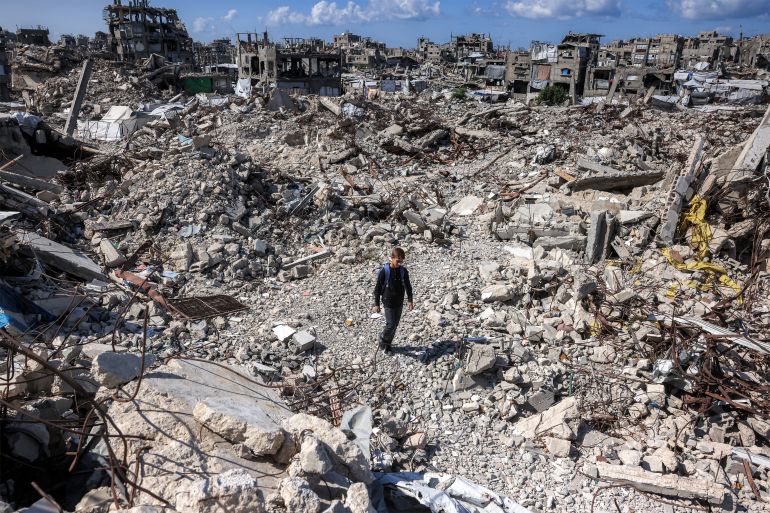 afp_6ad706f3b38f-1792476915-1 TOPSHOT - A boy walks across the rubble of collapsed buildings in the Jabalia camp for Palestinian refugees in the northern Gaza Strip on October 19, 2026.