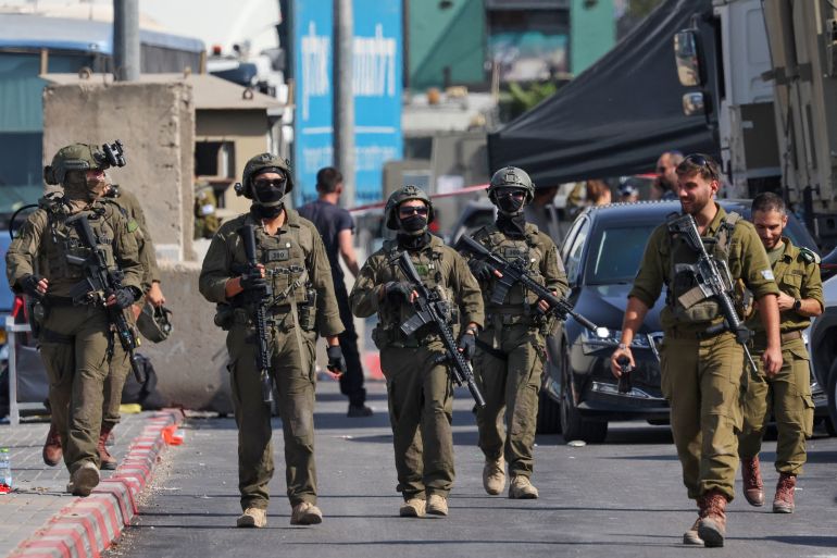 Israeli soldiers gather at the scene of an earlier fire exchange between armed Palestinians and Israeli forces following an incident at the norther checkpoint of Hebron in the Israeli-occupied West Bank on October 23, 2026.