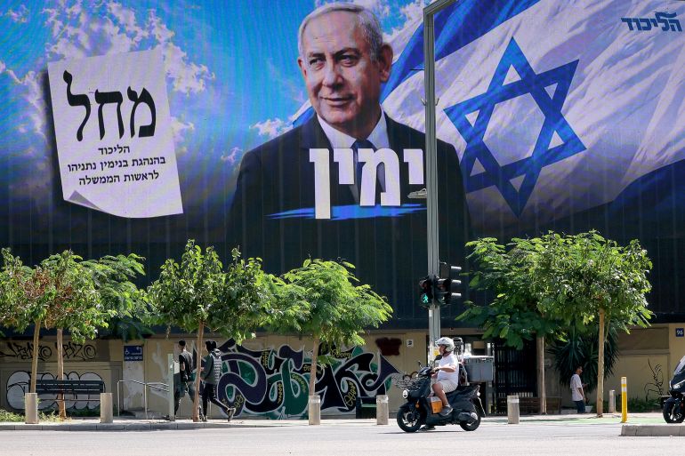 afp_6adcca7e8925-1792854654 A scooter rides past a billboard featuring Israel's Prime Minister Benjamin Netanyahu of the Likud party in Tel Aviv on October 20, 2026.