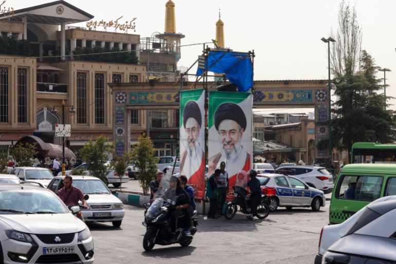afp_6adcfe6e24f0-1792867950 Traffic moves past portraits of Iran's supreme leader Ayatollah Mojtaba Khamenei in Tehran on October 21, 2026.