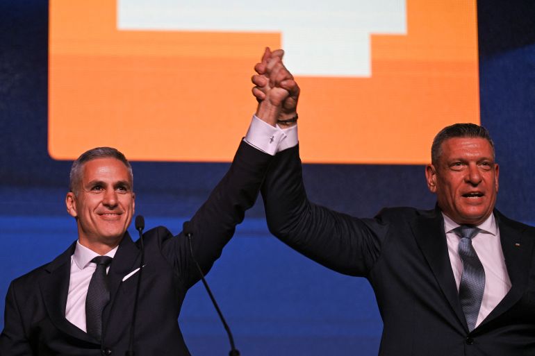 afp_6adda1576895-1792909655 Bulgaria's former interim Prime Minister and candidate for the 2026 Presidential election Andrey Gyurov (L) and vice presidential candidate Georgi Kandev (R) hold hands on stage during a campaign rally in Plovdiv, on October 21, 2026, ahead of the Presidential election on October 25.