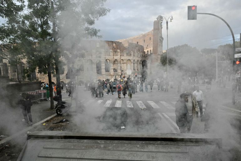 Smoke rises from a rubbish skip set on fire by protesters in front of the Colosseum during a demonstration, part of a nationwide day of strikes and protests as school and university students demand more funding for schools and support for housing, in Rome on October 30, 2026.