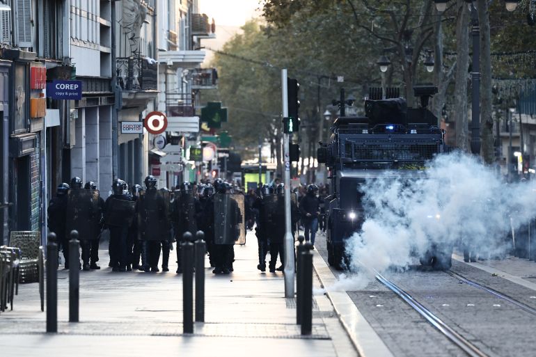 afp_6ae5aca366de-1793436835 French riot Police walk alongside a French gendarmerie "Centaure" multipurpose intervention vehicle (VIPG) during a demonstration in favor of purchasing power, the protection of public services, and fiscal and social justice, in Marseille, southeastern France on October 24, 2026 as part of a nationwide call for mobilisation bringing together former members of the Yellow Vest movement, labor unions, high school and university students.