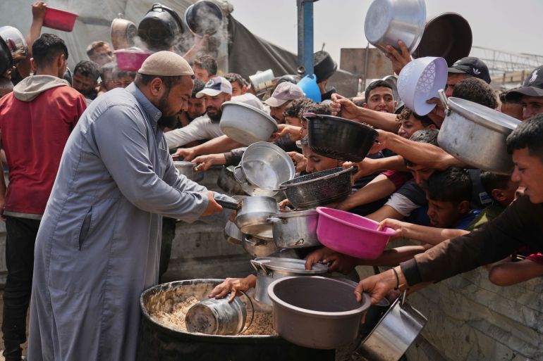 ap25111373067133-1745420057 Palestinian children receive donated food at a distribution center in Khan Younis, Gaza Strip, Monday, April 21, 2025. (AP Photo/Abdel Kareem Hana)