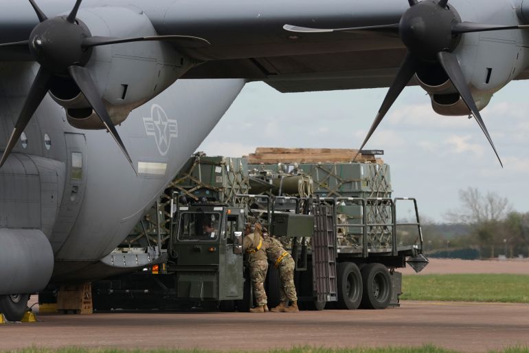 Munitions are unloaded from a cargo plane on the apron at RAF Fairford, England, Thursday, March 26, 2026. (AP Photo/Alastair Grant)