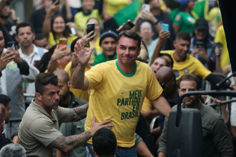 ap_6ac25087d24c2-1791119495 Opposition presidential candidate Flavio Bolsonaro waves to supporters during a campaign rally a day ahead of the country's general election, in Campo Grande, Rio de Janeiro state, Saturday, Oct. 3, 2026. (AP Photo/Bruna Prado)
