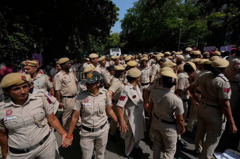ap_6ac4b95c0984a-1791277404 Police officers block a road during a protest organized by opposition parties demanding the resignation of the country's election chief Gyanesh Kumar in New Delhi, India, Tuesday, Oct. 6, 2026. (AP Photo/Manish Swarup)