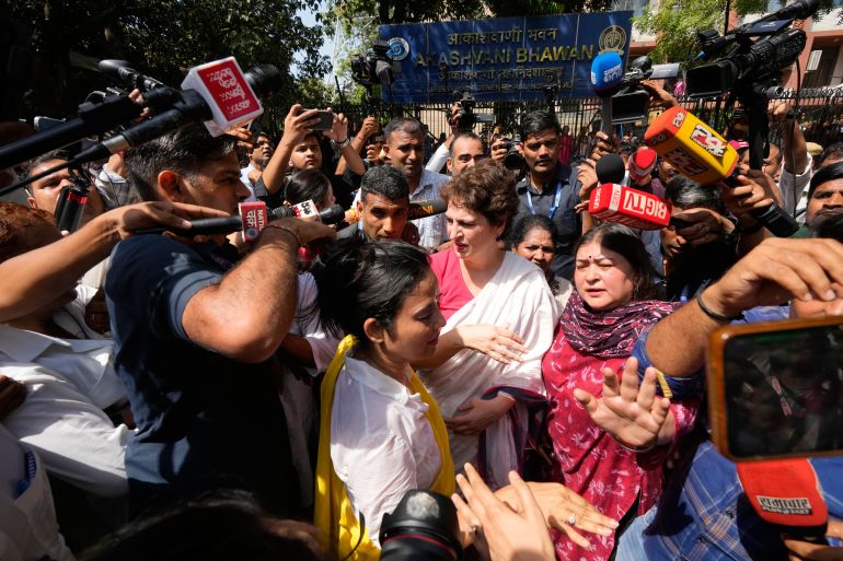 ap_6ac4bee55f981-1791278821 Congress party leader Priyanka Gandhi Vadra, center, is surrounded by journalists during a protest organized by opposition parties demanding the resignation of the country's election chief Gyanesh Kumar in New Delhi, India, Tuesday, Oct. 6, 2026. (AP Photo/Manish Swarup)