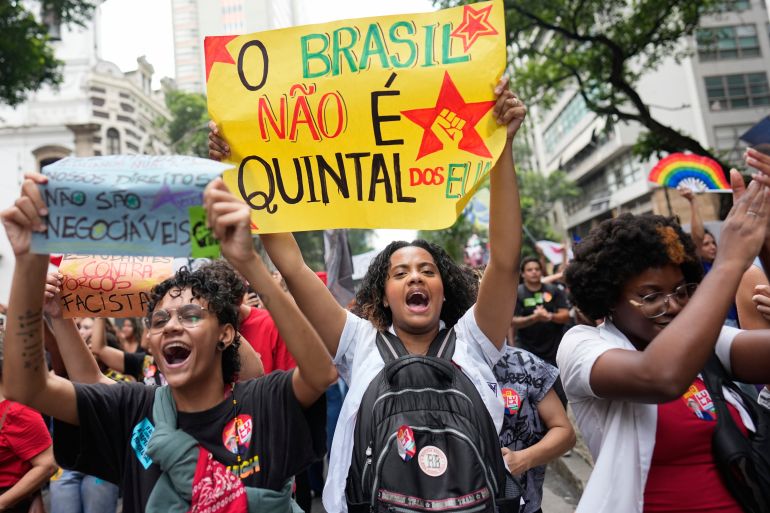 Students carry a sign that reads in Portuguese: "Brazil is not the backyard of the U.S." as they march to defend public education and support Brazilian President Luiz Inacio Lula da Silva, who is running for a fourth term, ahead of the presidential runoff election in Rio de Janeiro, Wednesday, Oct. 7, 2026. (AP Photo/Silvia Izquierdo)