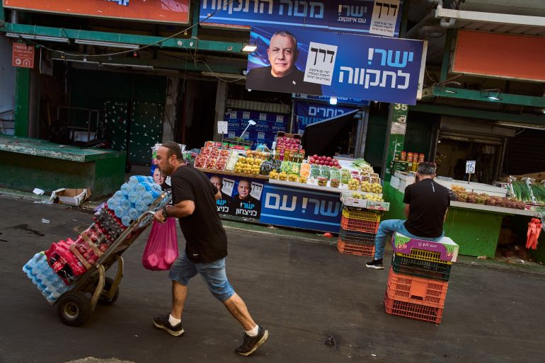 ap_6acd13107110c-1791824656 Election campaign posters featuring Gadi Eisenkot, leader of the centrist Yashar ("Straight") party, are displayed at a market ahead of Israel's general election, in Tel Aviv, Israel, Monday, Oct. 12, 2026. (AP Photo/Oded Balilty)