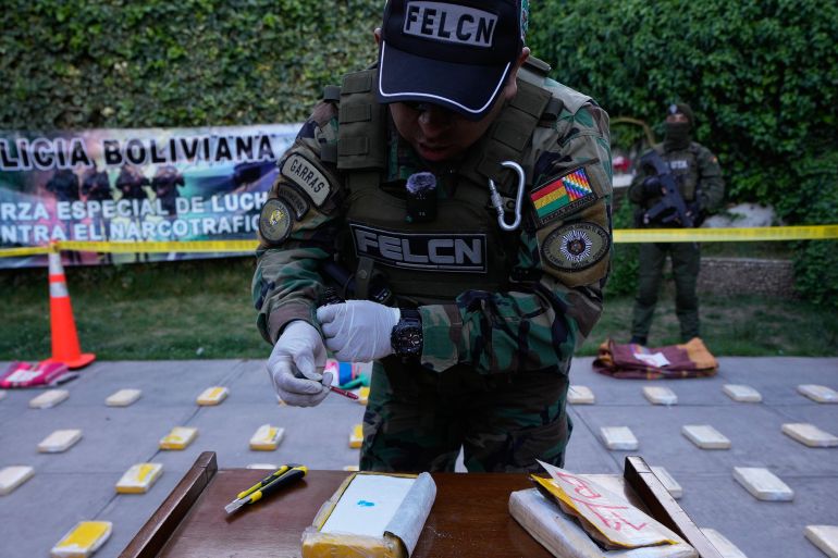 ap_6ad24d08c9d5d-1792167176 An anti-narcotics police officer tests a package of cocaine from a confiscated shipment during a media presentation in La Paz, Bolivia, Thursday, Oct. 8, 2026. (AP Photo/Juan Karita)
