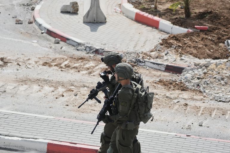 Israeli soldiers take up positions during an army operation in the West Bank city of Hebron Saturday, Oct. 24, 2026. A day after a Palestinian shooting attack in the area. (AP Photo/Mahmoud Illean)