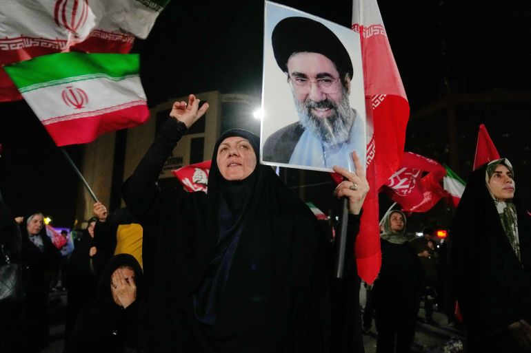 A demonstrator chants slogan as she holds a poster of the Iranian Supreme Leader Ayatollah Mojtaba Khamenei during a pro-government gathering at a square in Tehran, Thursday, Oct. 8, 2026. (AP Photo/Vahid Salemi)