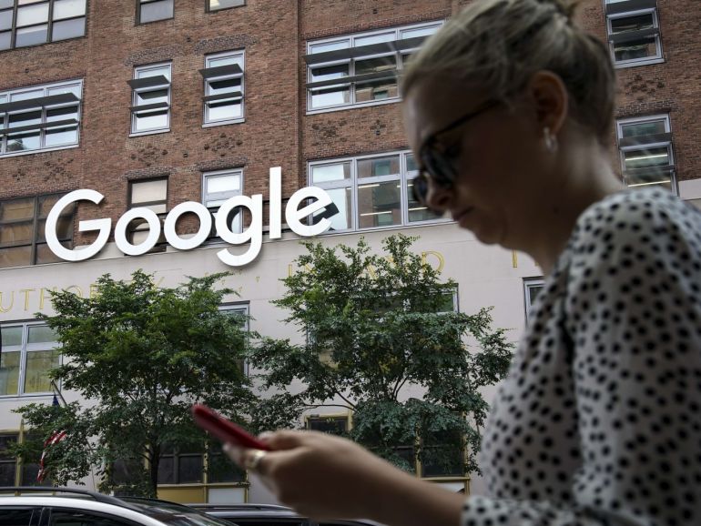 ce41ff2c-3e38-45d8-8976-1586fadab4a9 NEW YORK, NY - JUNE 3: A woman looks at her smartphone as she walks past Google Building 8510 at 85 10th Ave on June 3, 2019 in New York City. Shares of Google parent company Alphabet were down over six percent on Monday, following news reports that the U.S. Department of Justice is preparing to launch an anti-trust investigation aimed at Google. Drew Angerer/Getty Images/AFP== FOR NEWSPAPERS, INTERNET, TELCOS & TELEVISION USE ONLY ==