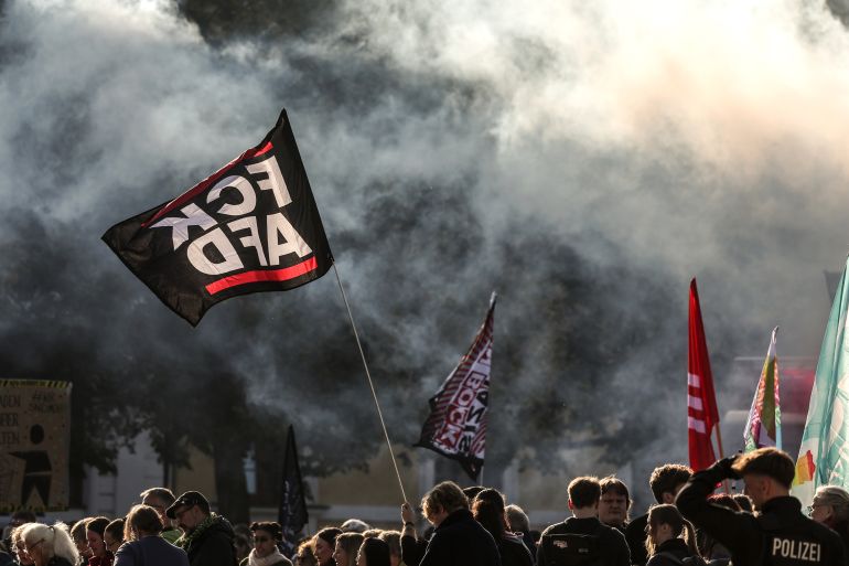 epaselect epa13284268 Demonstrators hold banners and flags during a protest against the far-right Alternative for Germany (AfD) party ahead of the constitutive session of Saxony-Anhalt's new state parliament, in Magdeburg, Germany, 06 October 2026. The newly elected members of the 9th State Parliament of Saxony-Anhalt are convening in Magdeburg for their inaugural session following the state election on 06 September 2026, in which the AfD emerged as the largest parliamentary group. EPA/FILIP SINGER