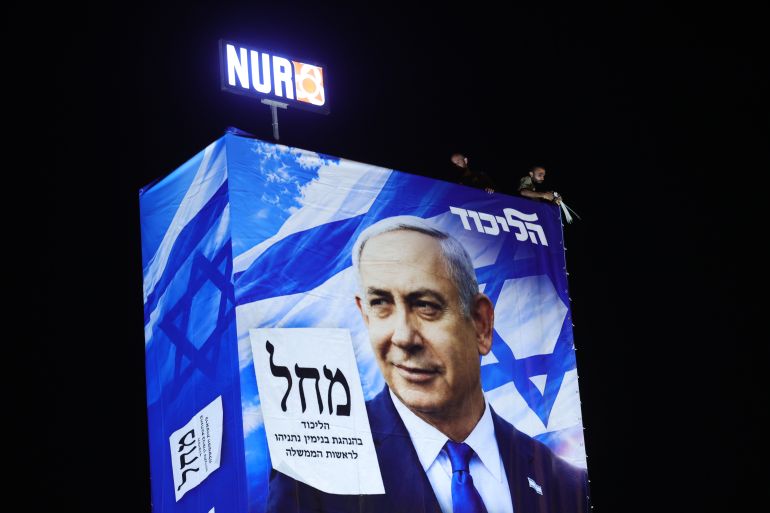 epa_6ad4fe1d55f7-1792343581 epa13312967 Rappelling workers install an election billboard featuring an image of Israeli Prime Minister Benjamin Netanyahu, and reading in Hebrew 'It's either the Right or Palestine,' in Ramat Gan near Tel Aviv, Israel, 18 October 2026. Israel will hold legislative elections on 27 October 2026. EPA/ABIR SULTAN
