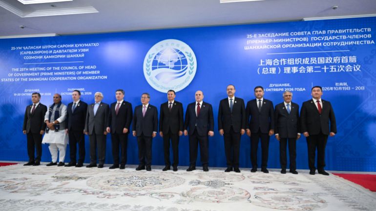 epa_6ad8aba28114-1792584610 epa13316577 (L-R) SCO Secretary-General Nurlan Yermekbayev, Indian Defence Minister Rajnath Singh, Belarusian Prime Minister Alexander Turchin, Iranian First Vice President Mohammad Reza Aref, Kazakh Prime Minister Olzhas Bektenov, Chinese Premier Li Qiang, Tajik Prime Minister Kokhir Rasulzoda, Russian Prime Minister Mikhail Mishustin, Uzbek Prime Minister Abdulla Aripov, Kyrgyz First Deputy Prime Minister Daniyar Amangeldiev, Pakistani Deputy Prime Minister - Foreign Minister Mohammad Ishaq Dar and SCO Regional Anti-Terrorist Structure (RATS) Executive Committee Director Ularbek Sharsheev pose for a family photo before a narrow format meeting of the Council of the Heads of Government of the Shanghai Cooperation Organisation (SCO) member states in Dushanbe, Tajikistan, 20 October 2026. EPA/ALEXANDER MIRIDONOV / SPUTNIK / GOVERNMENT PRESS SERVICE / POOL MANDATORY CREDIT