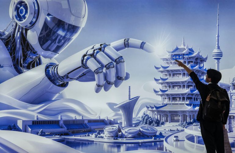 BEIJING, CHINA - JUNE 26: A visitor poses for a friend in front of a billboard showing a humanoid robot in the AI section at the Chinese International Supply Chain Expo (CISCE) on June 26, 2026 in Beijing, China. China is investing heavily in artificial intelligence and robotics, pouring billions of dollars into what the government sees as the country’s next economic engine. There are thousands of Chinese companies across a sprawling sector that includes humanoid robot and embodied intelligence, AI models, factory automation, and AI for autonomous systems. China remains in a race with the United States for dominance in AI technologies with products that are cheaper to manufacture and have commercial appeal. (Photo by Kevin Frayer/Getty Images)