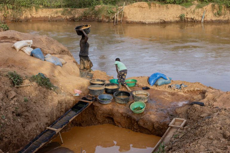 getty_6ad11a1cc3-1792088604 MONGBWALU, DEMOCRATIC REPUBLIC OF CONGO - MAY 27: Siblings wash gold-bearing sediment along a river at an artisanal gold mining site on May 27, 2026 in Mongbwalu, Democratic Republic of Congo. Artisanal gold mining is the town's primary economic activity, attracting workers from across the region and supporting thousands of households, while the mobility of mining communities presents additional challenges for Ebola surveillance and response efforts. The World Health Organization (WHO) and the Africa Centres for Disease Control and Prevention (Africa CDC) are deploying rapid response teams to reinforce infection prevention protocols and safe burial practices. However, aid cuts have weakened frontline preparedness, and transmission is currently outpacing field containment capabilities. The current Ebola epidemic in the DRC is caused by the Bundibugyo virus for which there are no approved vaccines. The highest number of cases have been reported in Congo's eastern Ituri province, bordering Uganda. Global health officials have expressed grave concern over the capacity to contain the outbreak in a region already facing a humanitarian crisis, with highly mobile populations displaced by conflict and economic factors. (Photo by Michel Lunanga/Getty Images)
