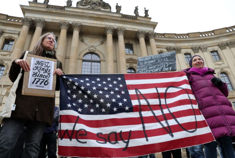 BERLIN, GERMANY - MARCH 28: Activists attend a "No Kings" protest against the current U.S. federal government on March 28, 2026 in Berlin, Germany. Millions worldwide, including in all 50 U.S. states, are expected to participate in over 3,000 such protests against the Trump administration's actions and policies and in support of topics ranging from abortion access and gun control to immigration and voting rights, in the third instance of the demonstration organized by labor unions and other grassroots organizations. (Photo by Adam Berry/Getty Images)